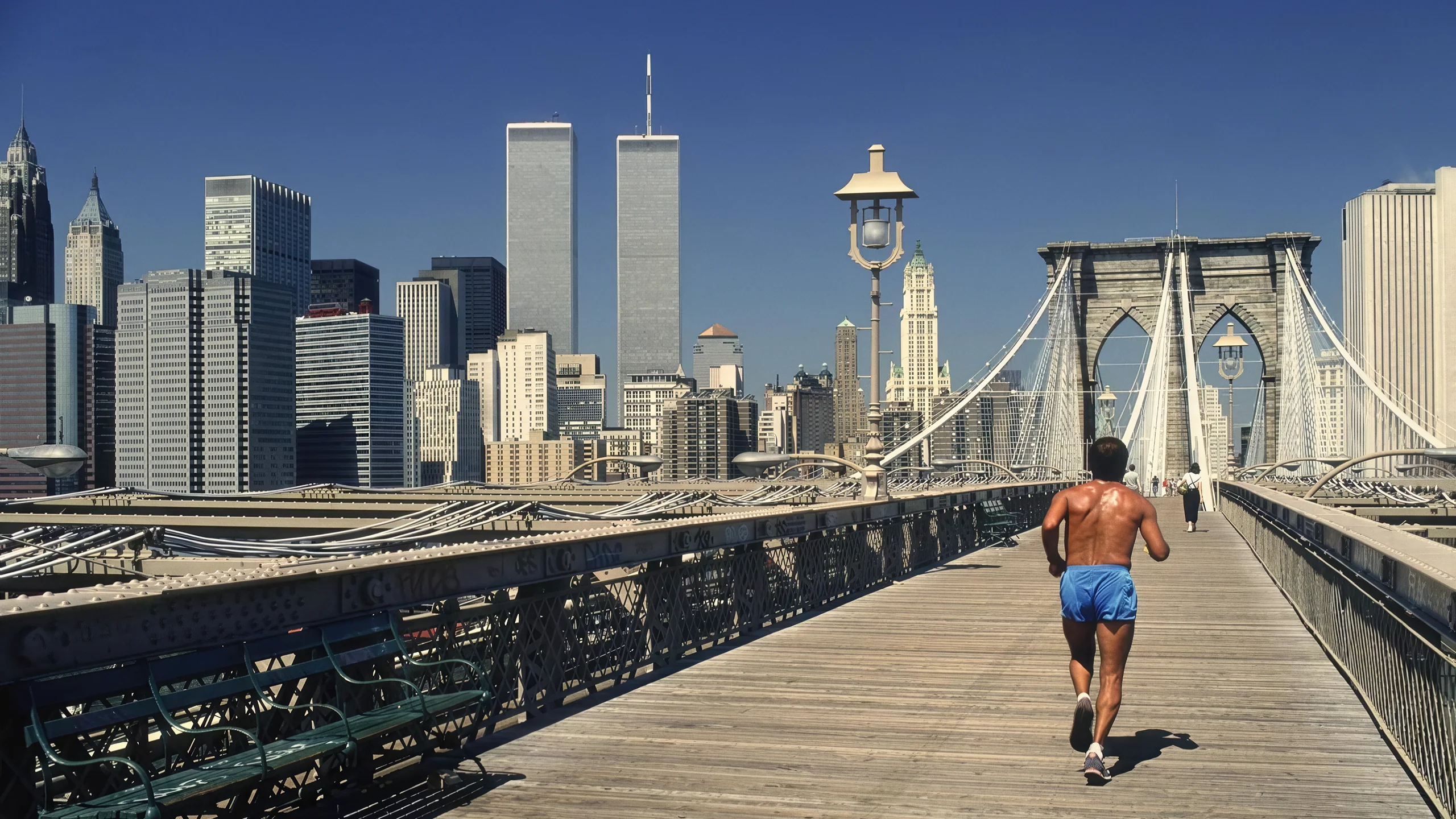 Taking a jog on Brooklyn Bridge with Twin Towers by Dino Fracchia, 1985 picture 1 of 1