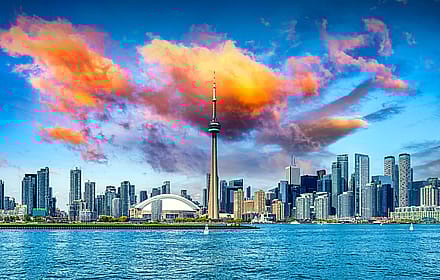 Golden Hour Over Toronto The Skyline Glowing Under Painted Skies Wallpaper'